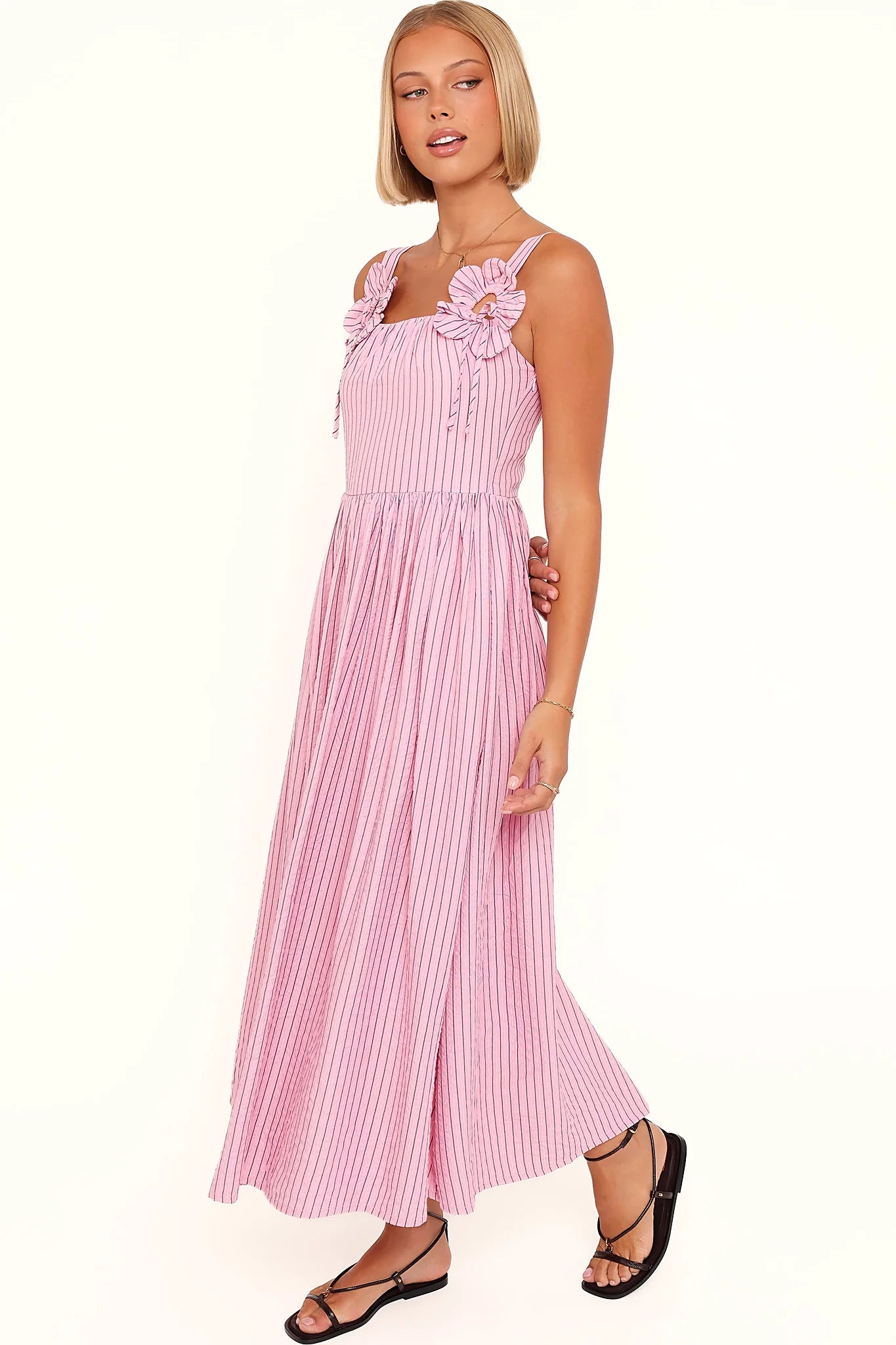 Back view of the pink & white stripe maxi dress on a model