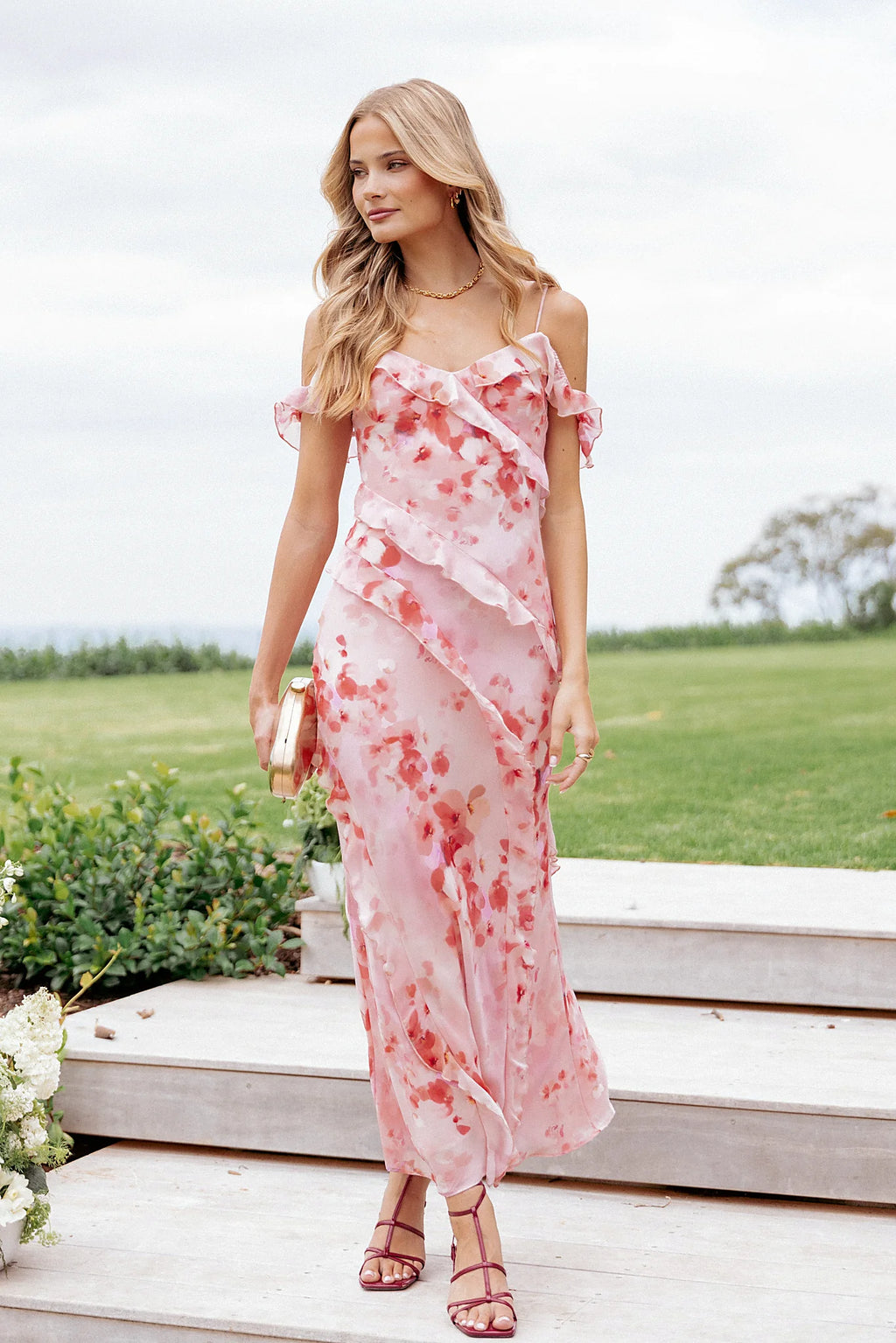 Close-up of the neckline of the pink floral off-shoulder maxi dress