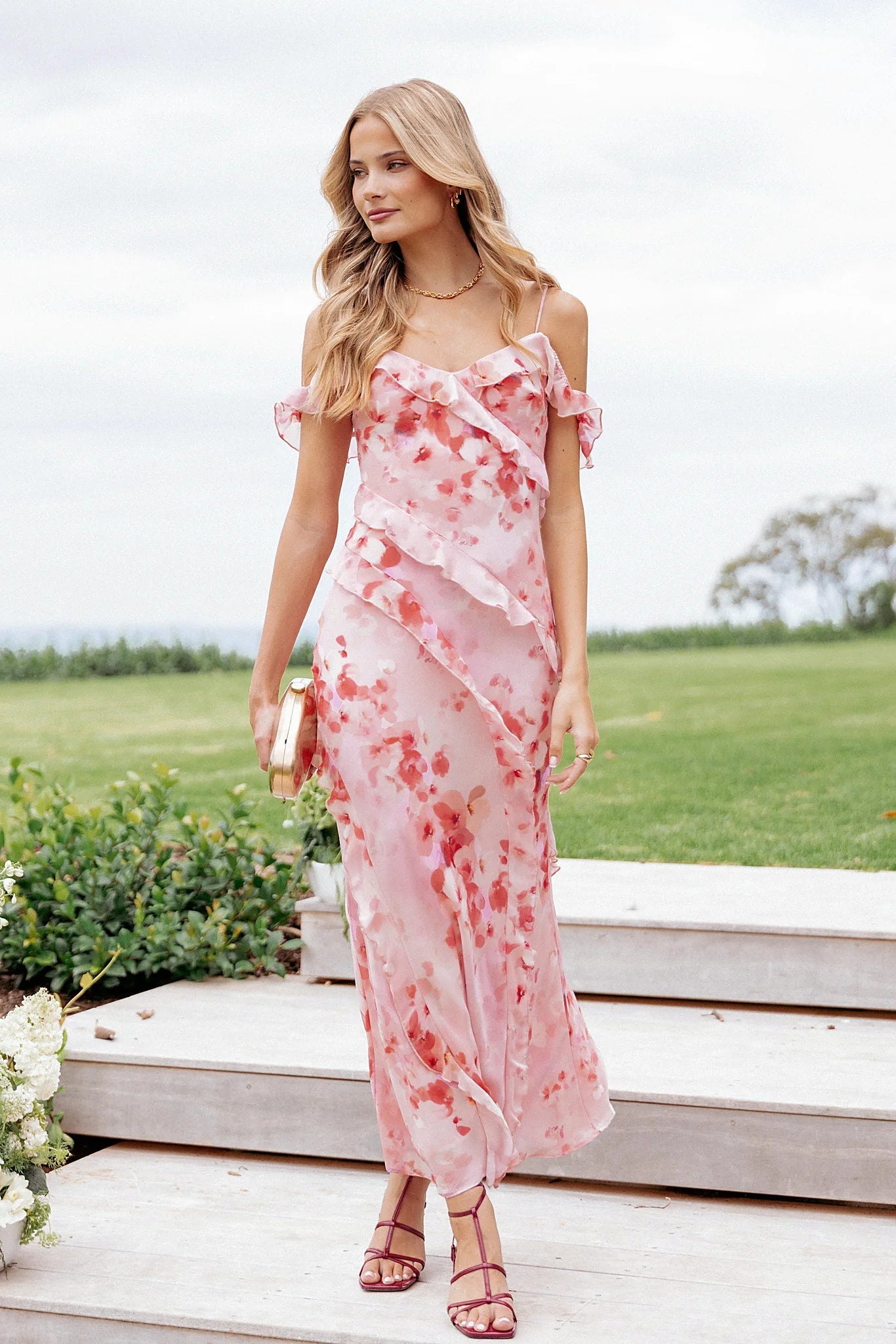 Close-up of the neckline of the pink floral off-shoulder maxi dress