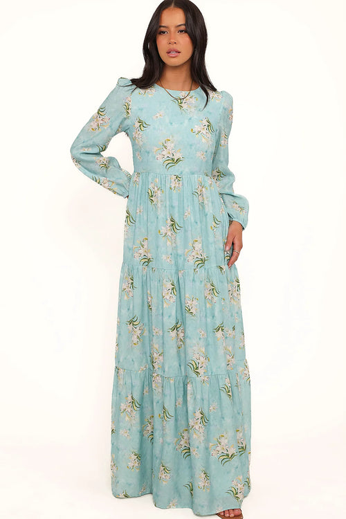 Side view showing the drape of the blue floral a-line maxi dress