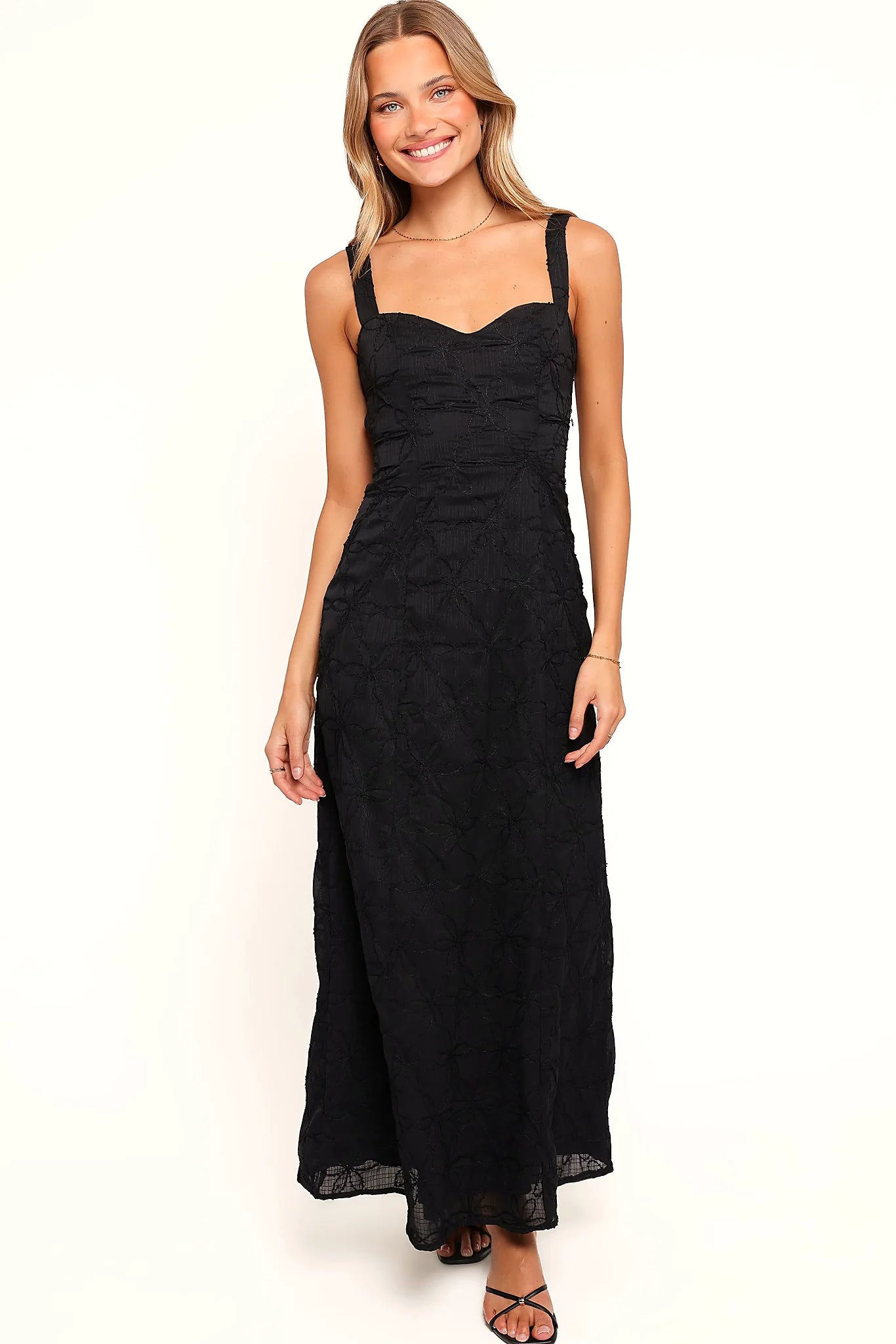 Back view of the black floral embroidered maxi dress on a model