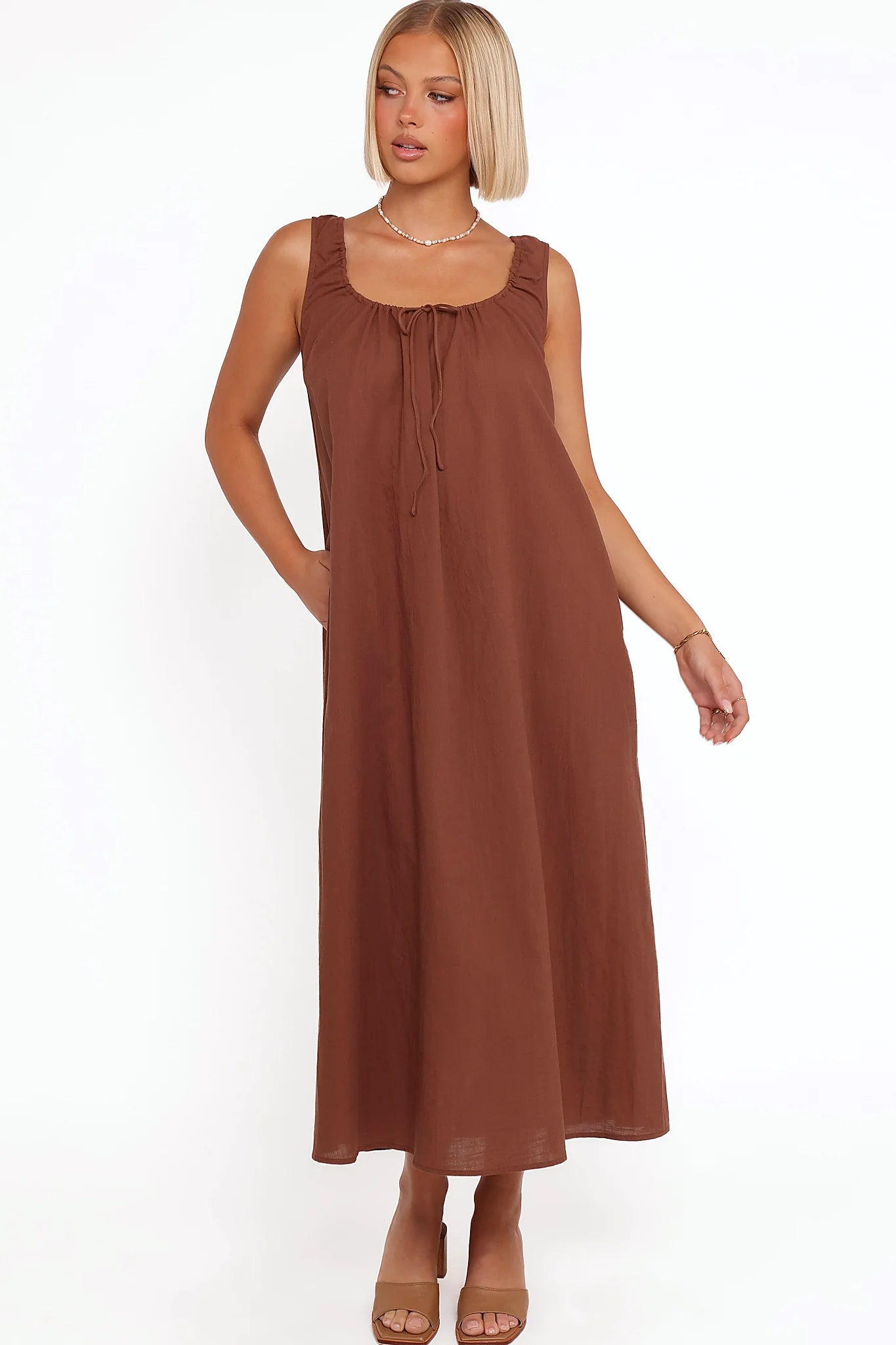 Back view of the chocolate brown tie-front maxi dress on a model