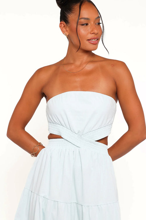 Side view showing the drape of the blue strapless maxi dress