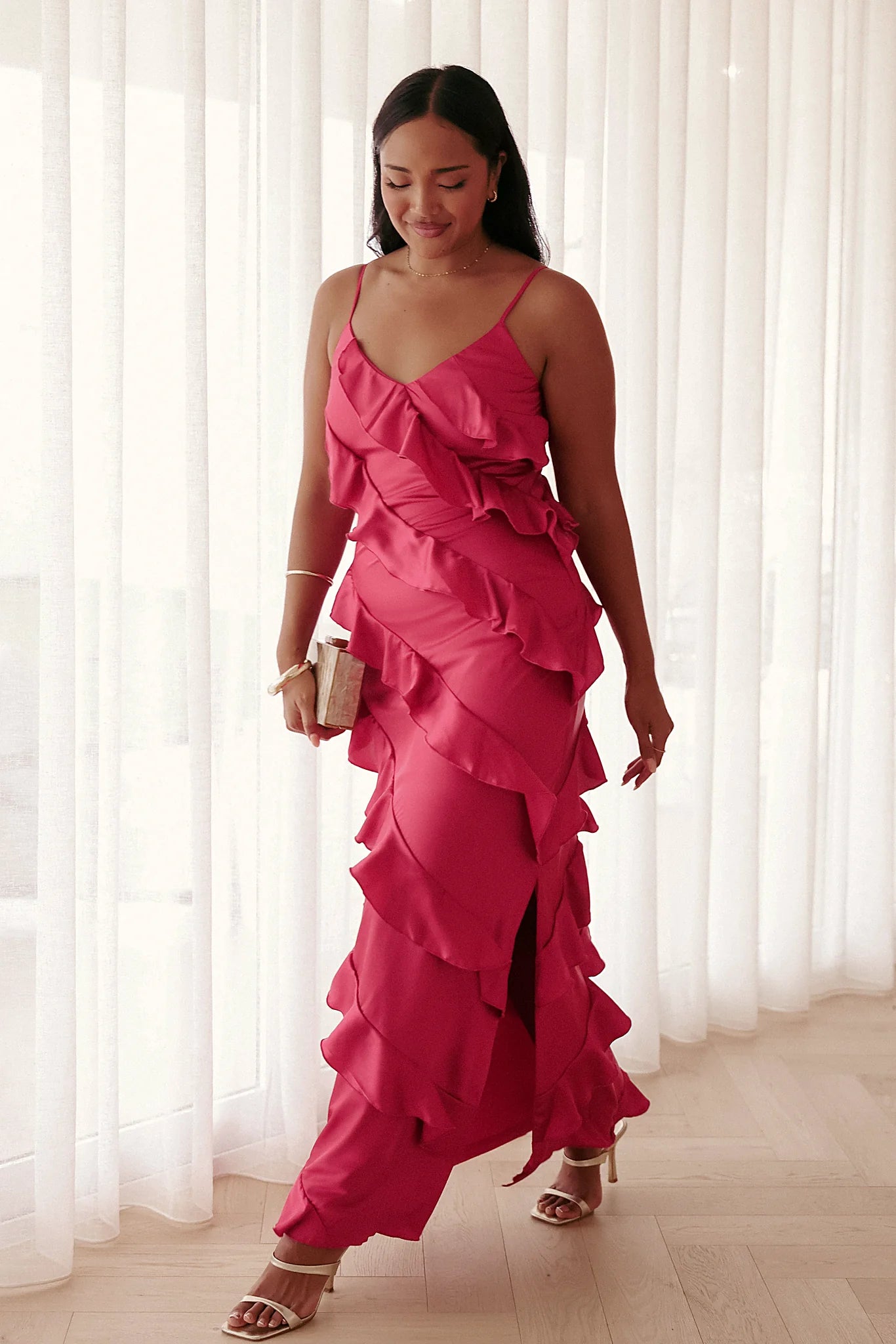 Model wearing the fuchsia ruffle satin maxi dress, front view