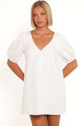 Model wearing the cream puff-sleeve mini dress, front view