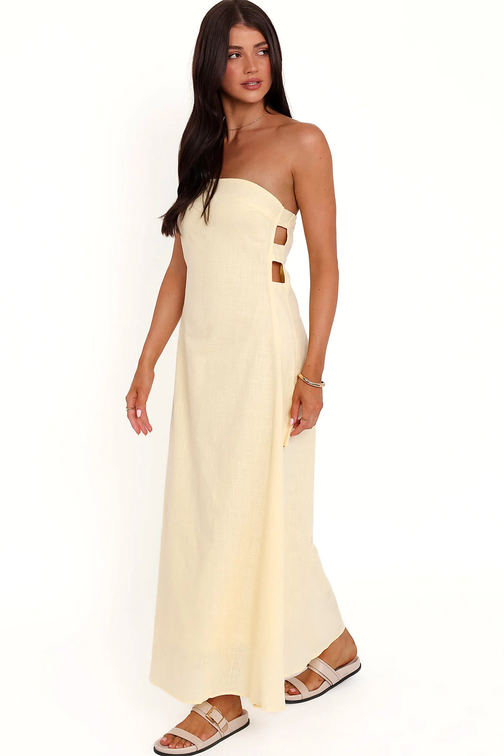 Back view of the butter yellow strapless maxi dress on a model