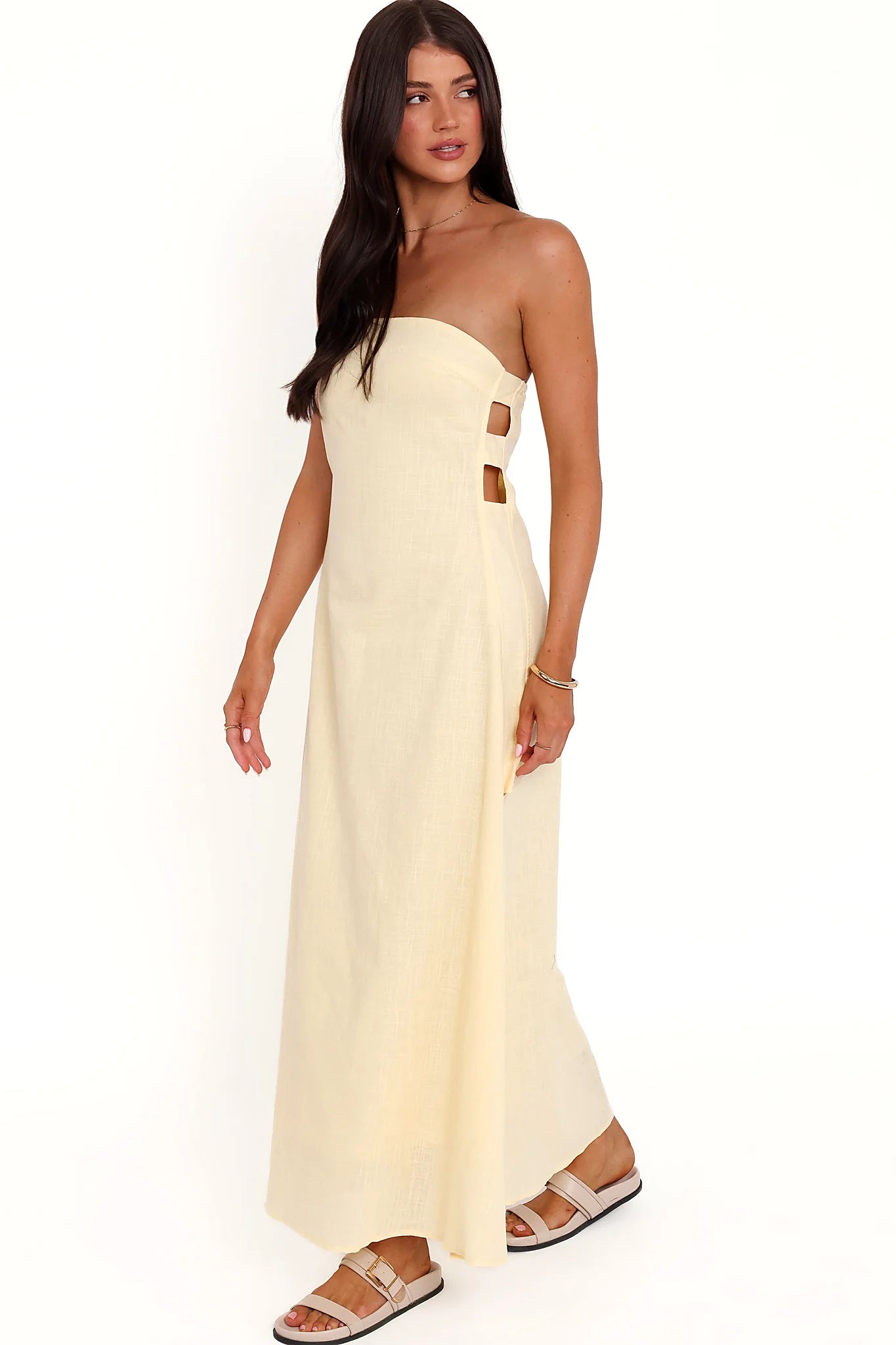 Back view of the butter yellow strapless maxi dress on a model
