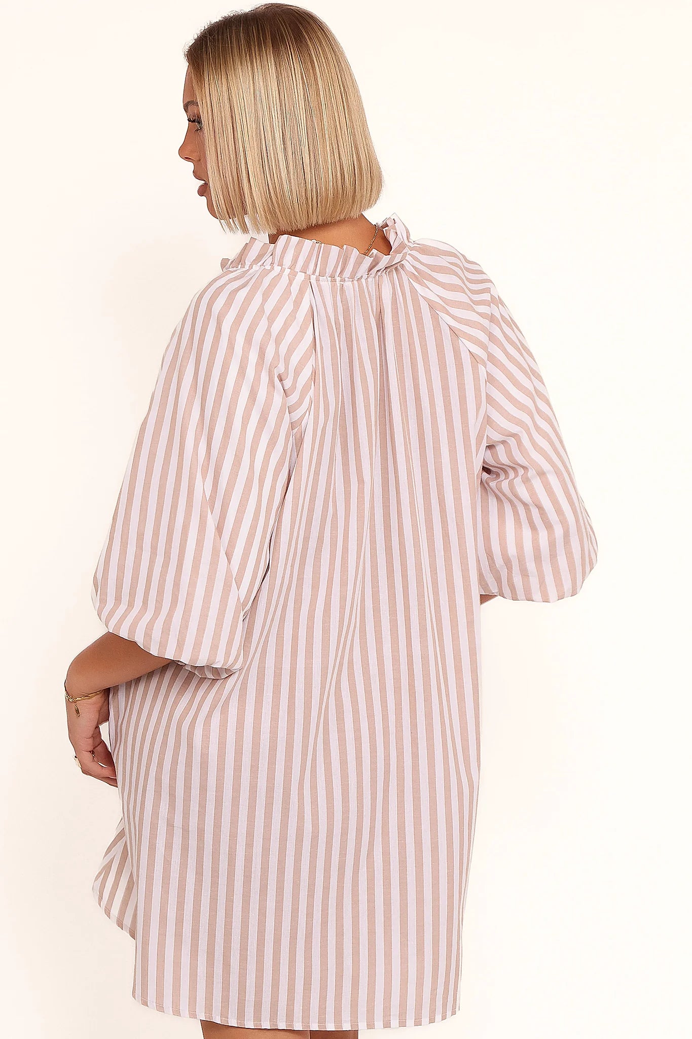 Full-length view of the beige & white stripe mini dress