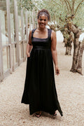 Full-length view of the black satin-feel maxi dress