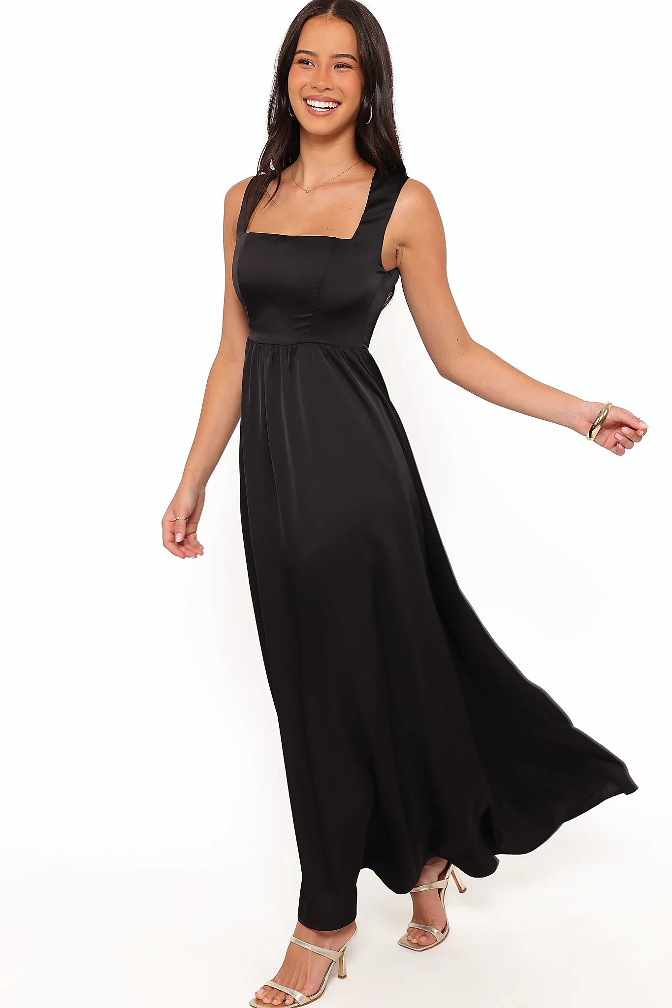 Model wearing the black satin-feel maxi dress, front view
