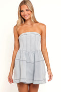 Close-up of the neckline of the light denim strapless mini dress