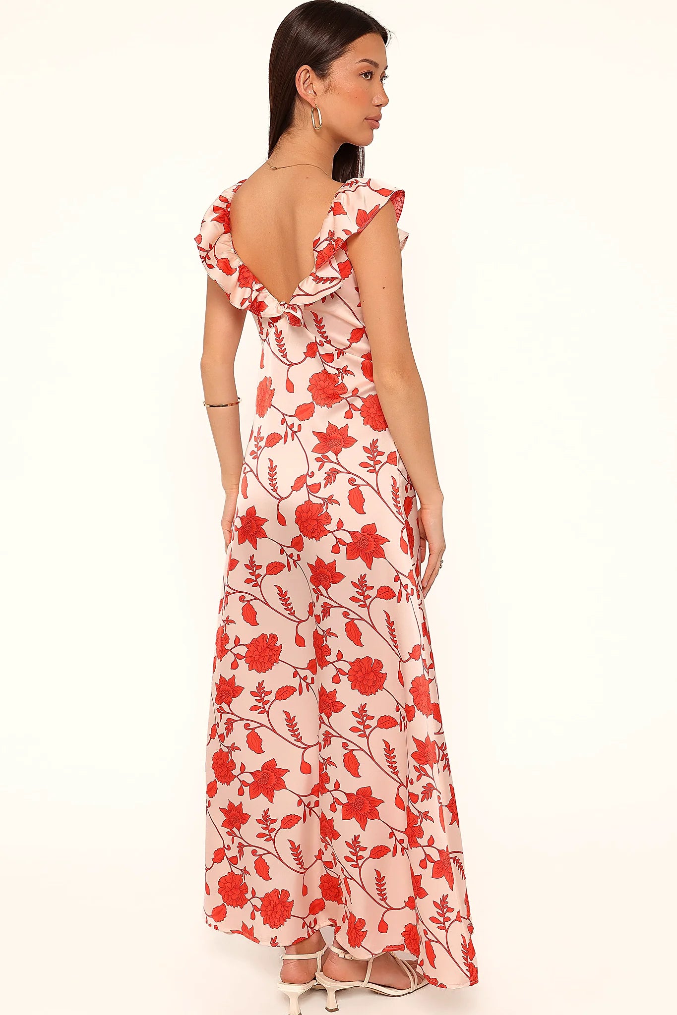 Side view showing the drape of the red floral maxi dress