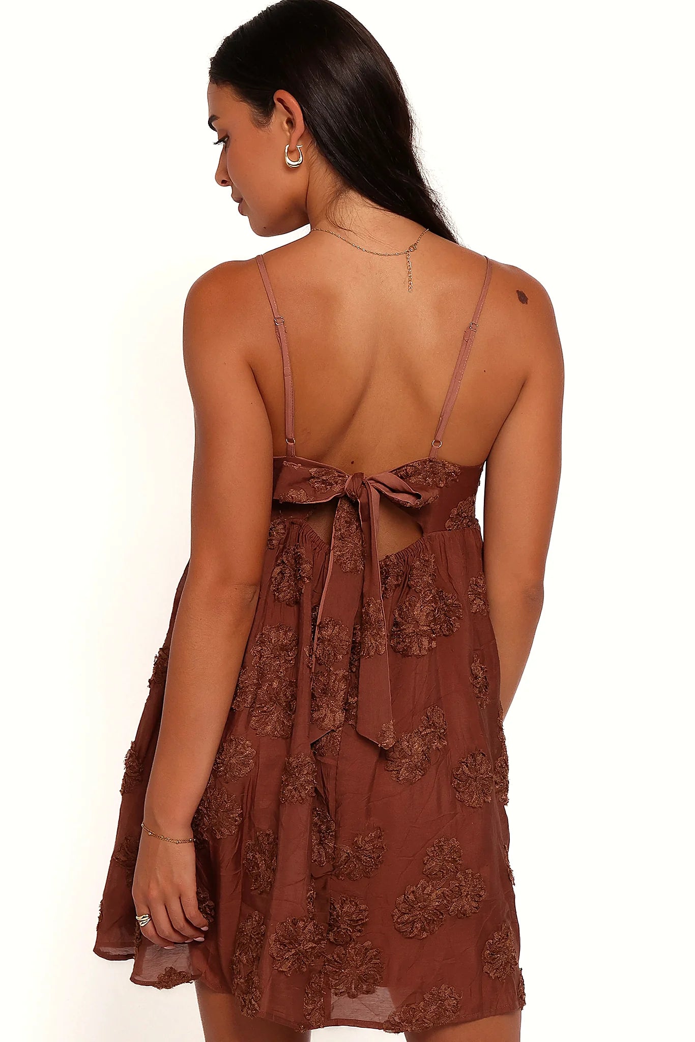 Model wearing the brown textured floral mini dress, front view