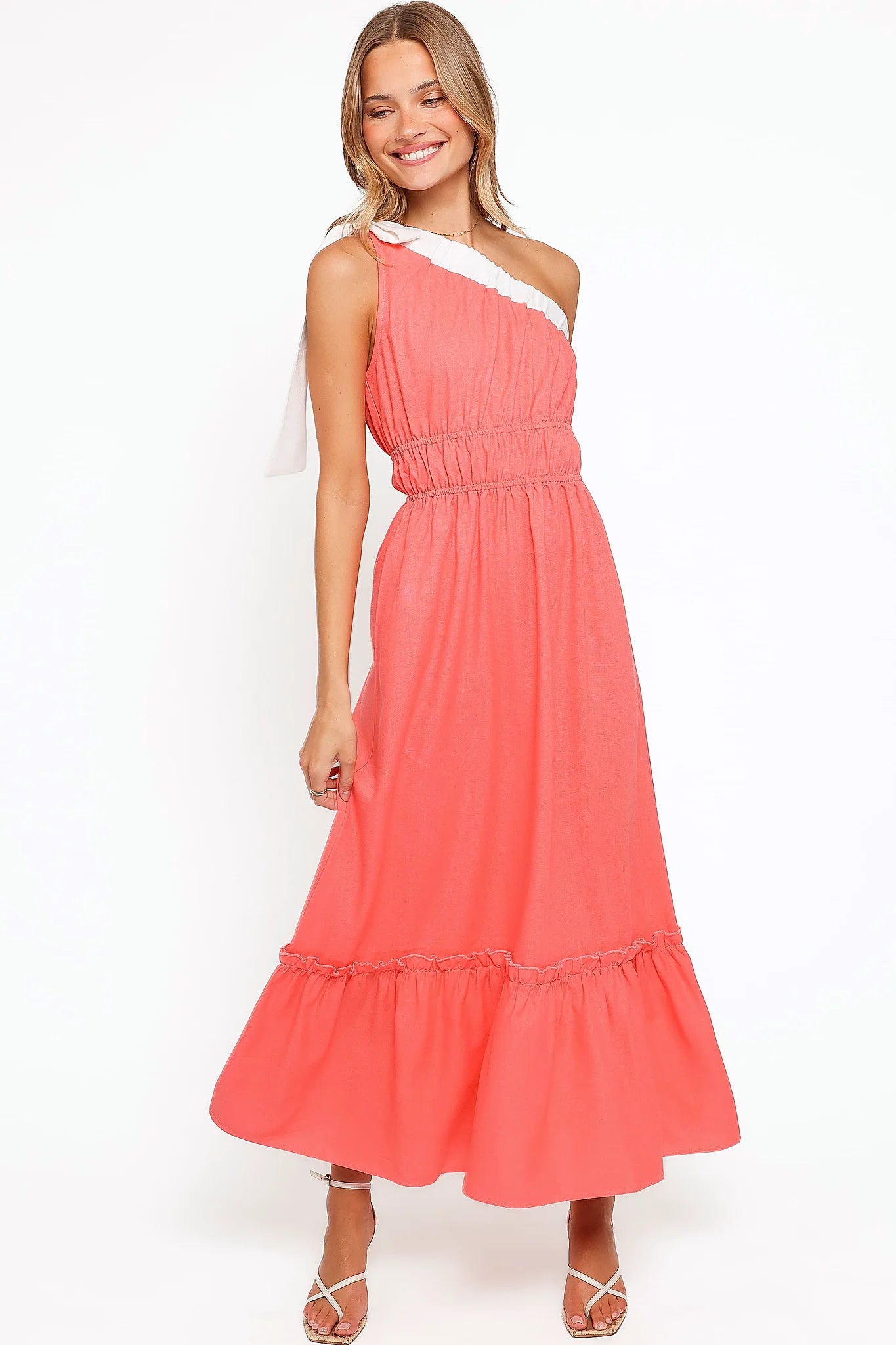 Close-up of the neckline of the coral one-shoulder maxi dress