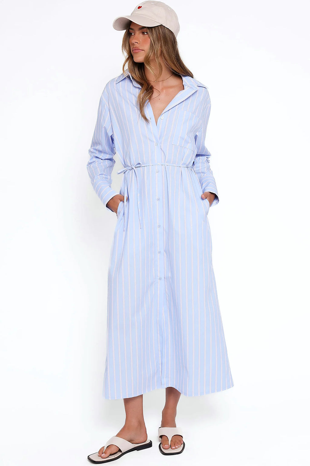 Model wearing the blue & pink stripe long sleeve midi dress, front view
