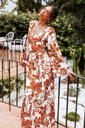 Side view showing the drape of the brown floral bead-detail maxi dress