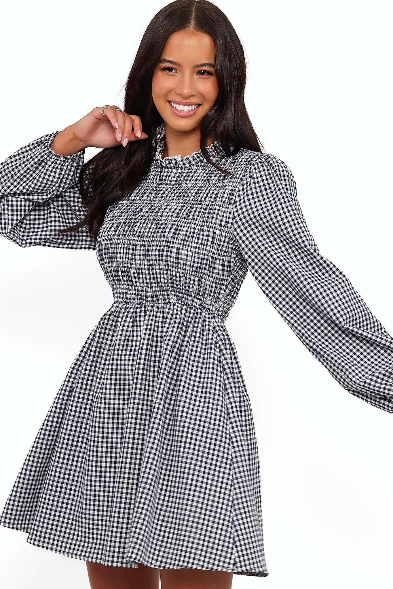 Side view showing the drape of the navy gingham long sleeve mini dress