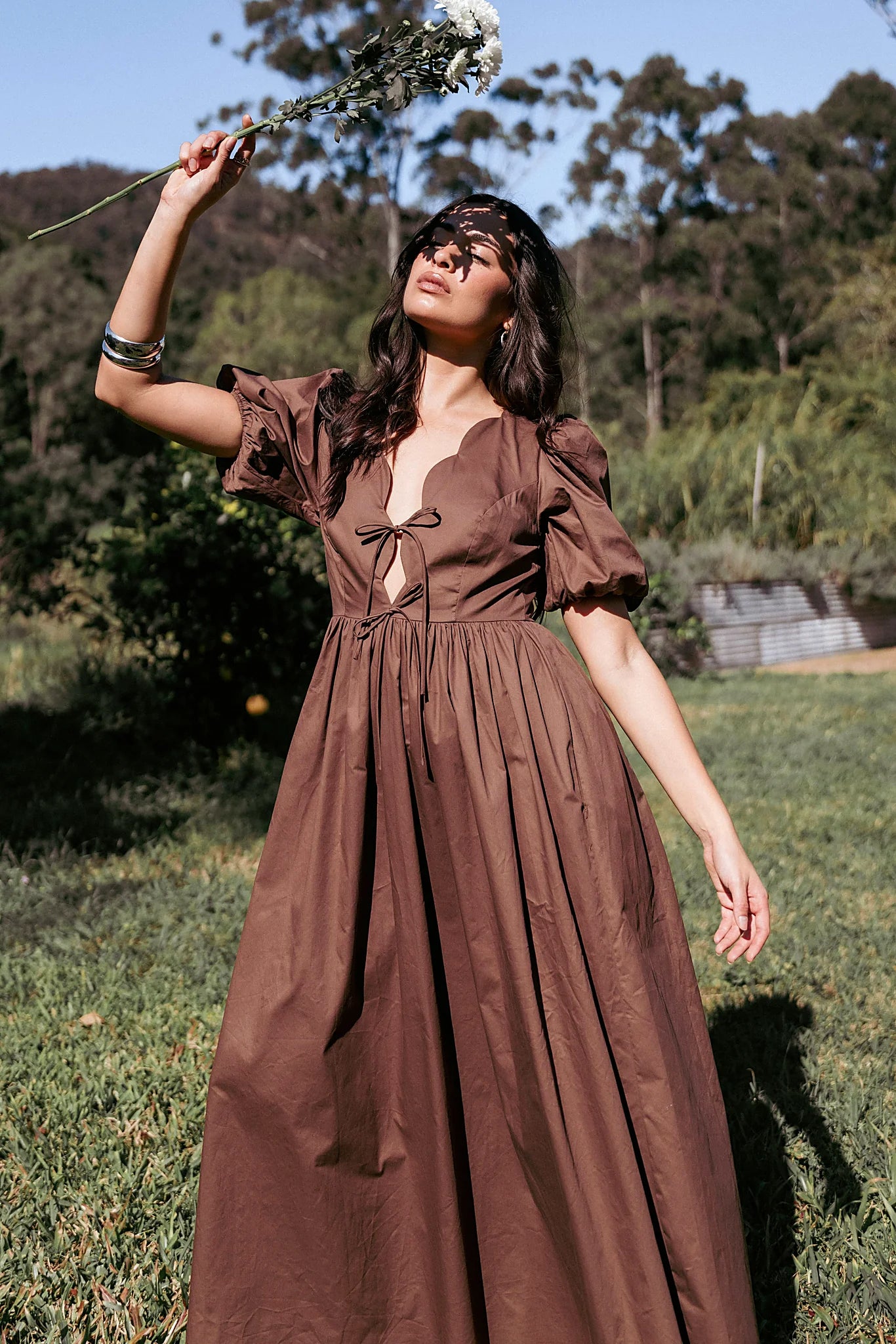 Model wearing the bitter chocolate empire maxi dress, front view