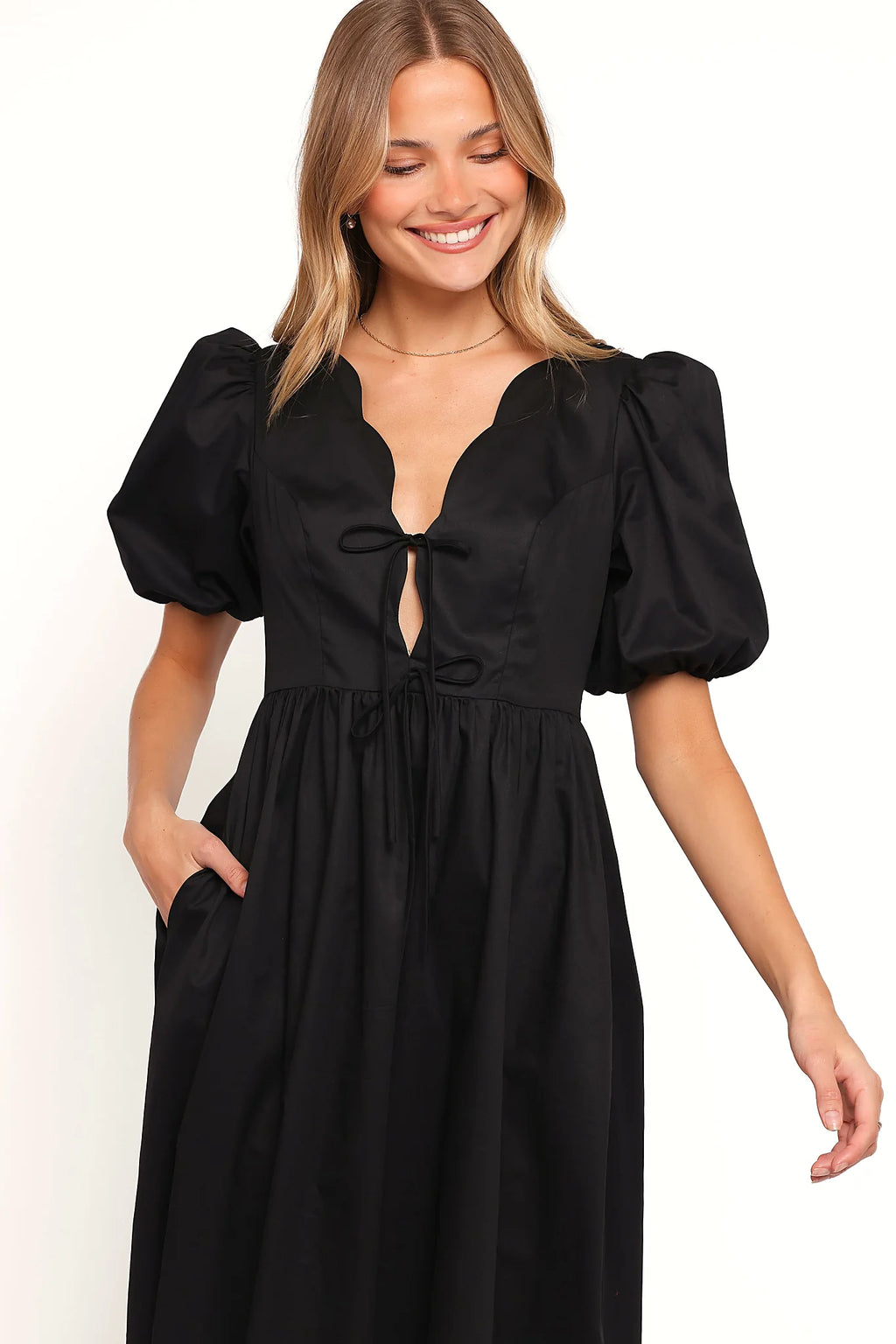 Close-up of the neckline of the black empire waist maxi dress