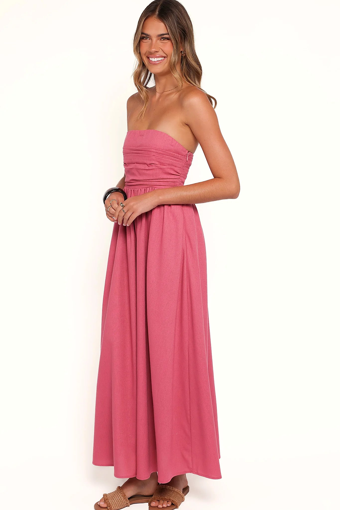 Back view of the petal pink strapless maxi dress on a model