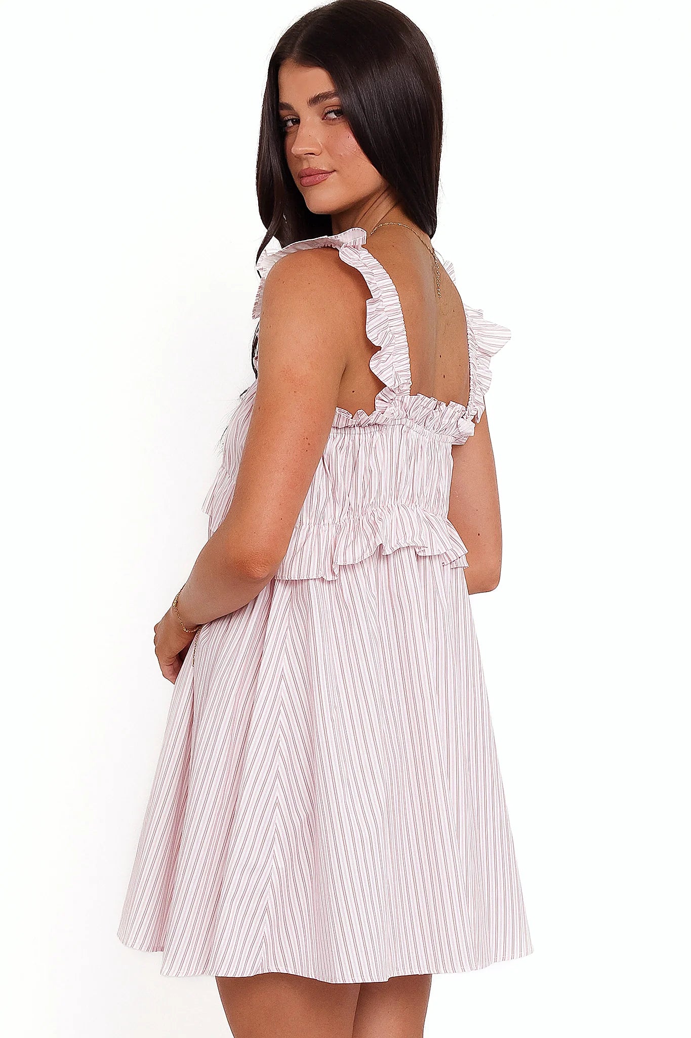 Back view of the pink stripe mini dress on a model