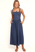 Side view showing the drape of the denim square-neck midi dress