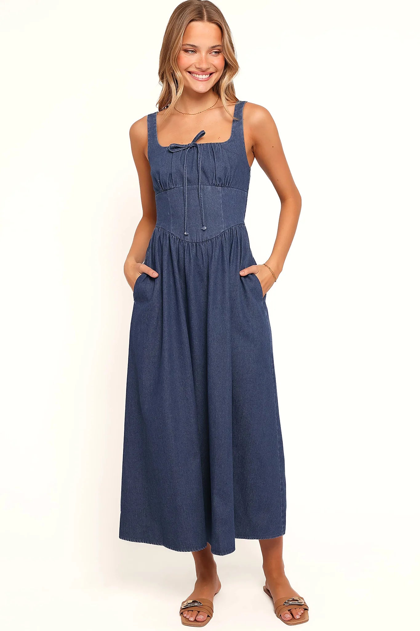 Side view showing the drape of the denim square-neck midi dress
