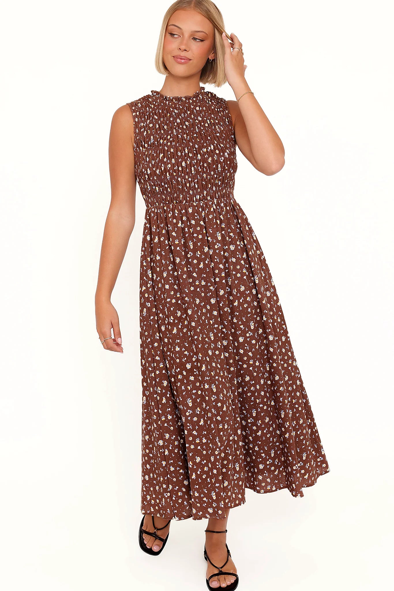 Side view showing the drape of the brown floral frill-neck maxi dress