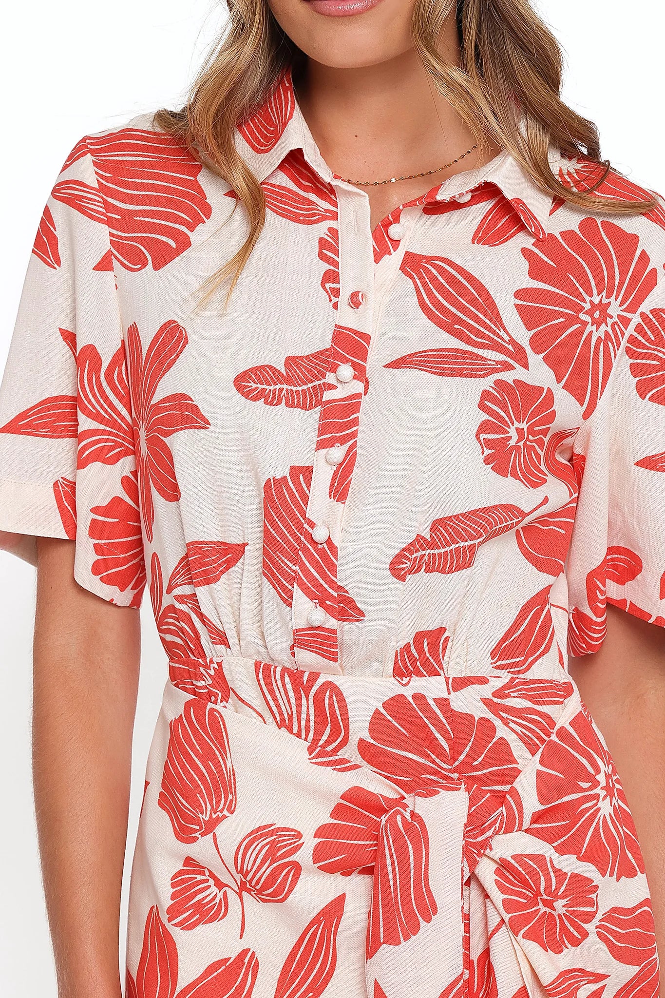 Close-up of the neckline of the red floral collared mini dress