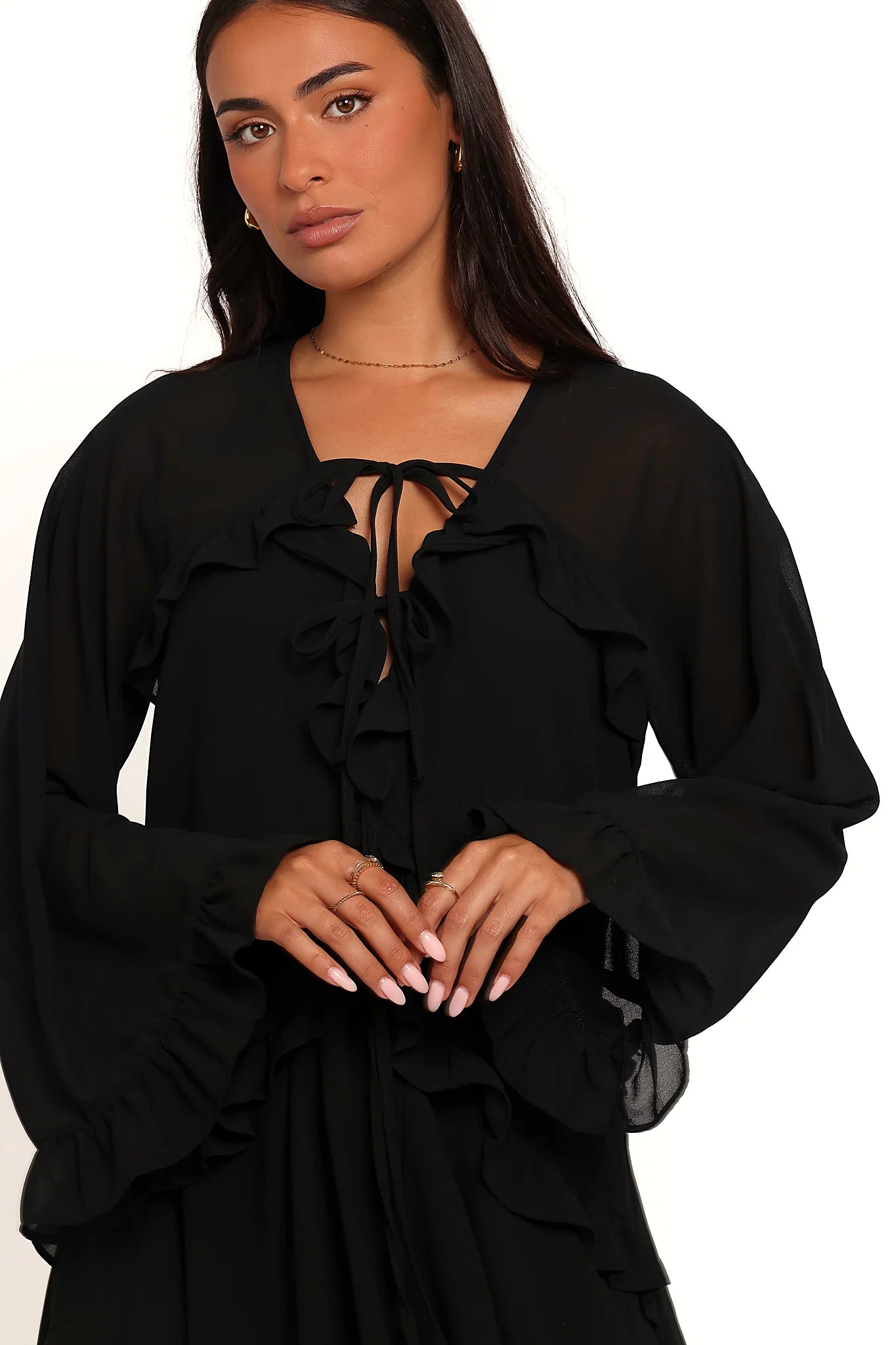Detail view of the black flare-sleeve mini dress