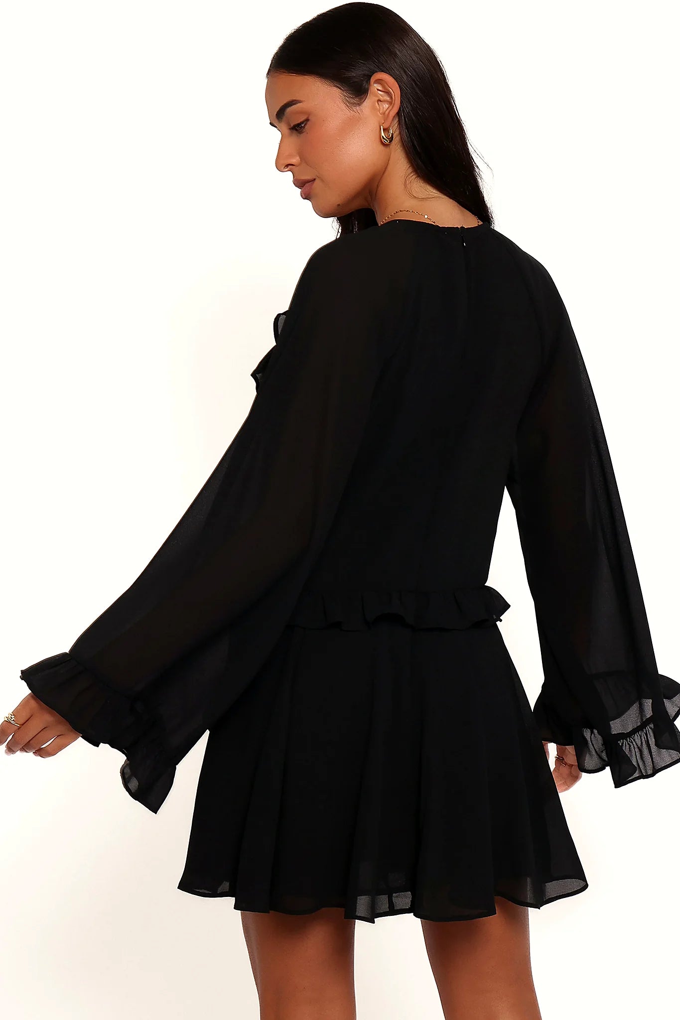 Close-up of the neckline of the black flare-sleeve mini dress