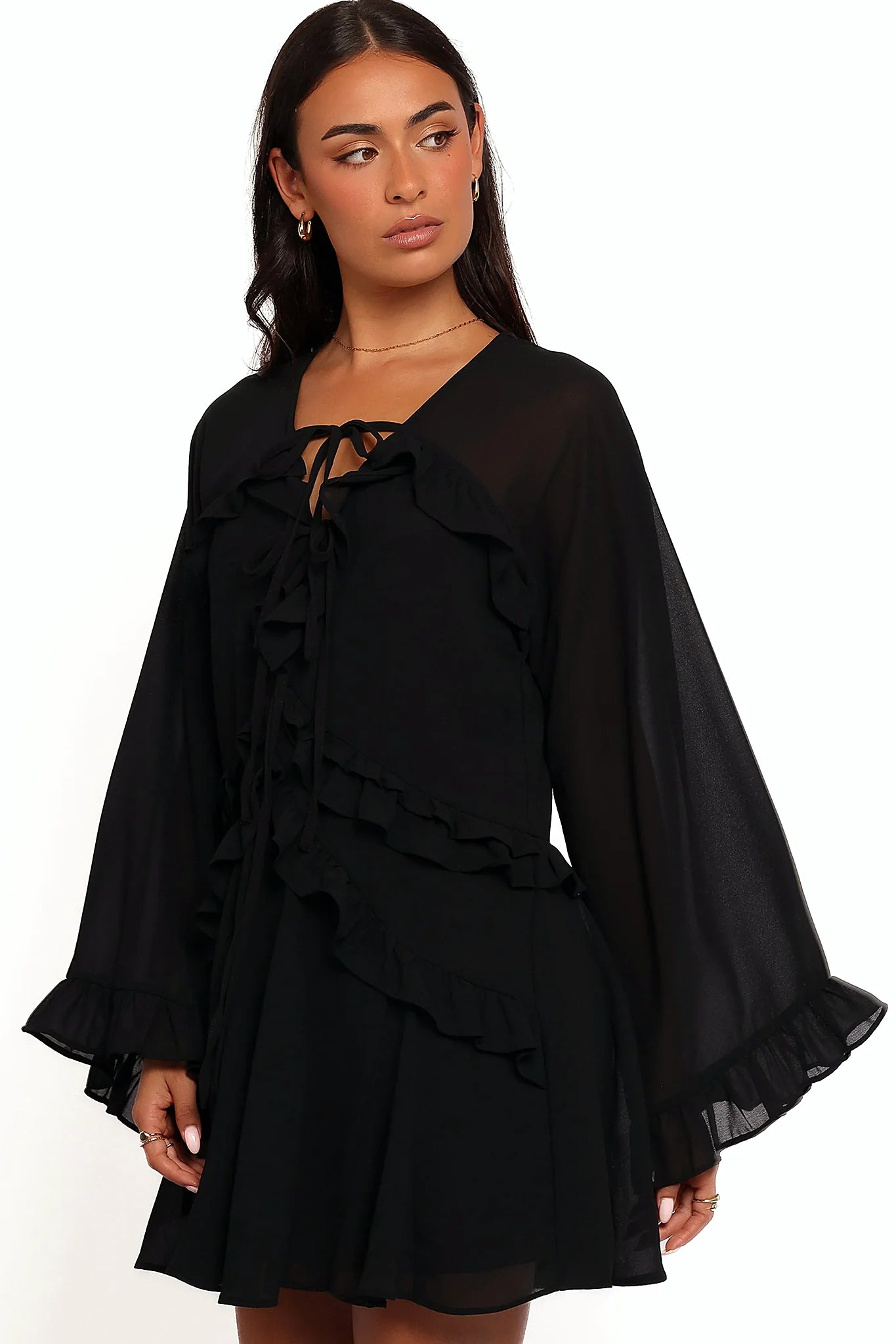Full-length view of the black flare-sleeve mini dress