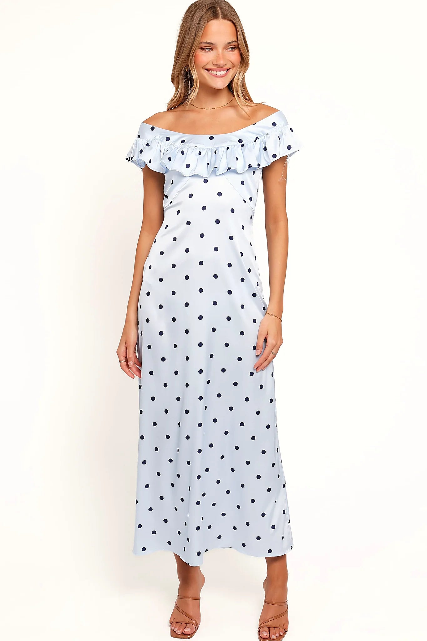 Close-up of the neckline of the blue polka dot off-shoulder maxi dress