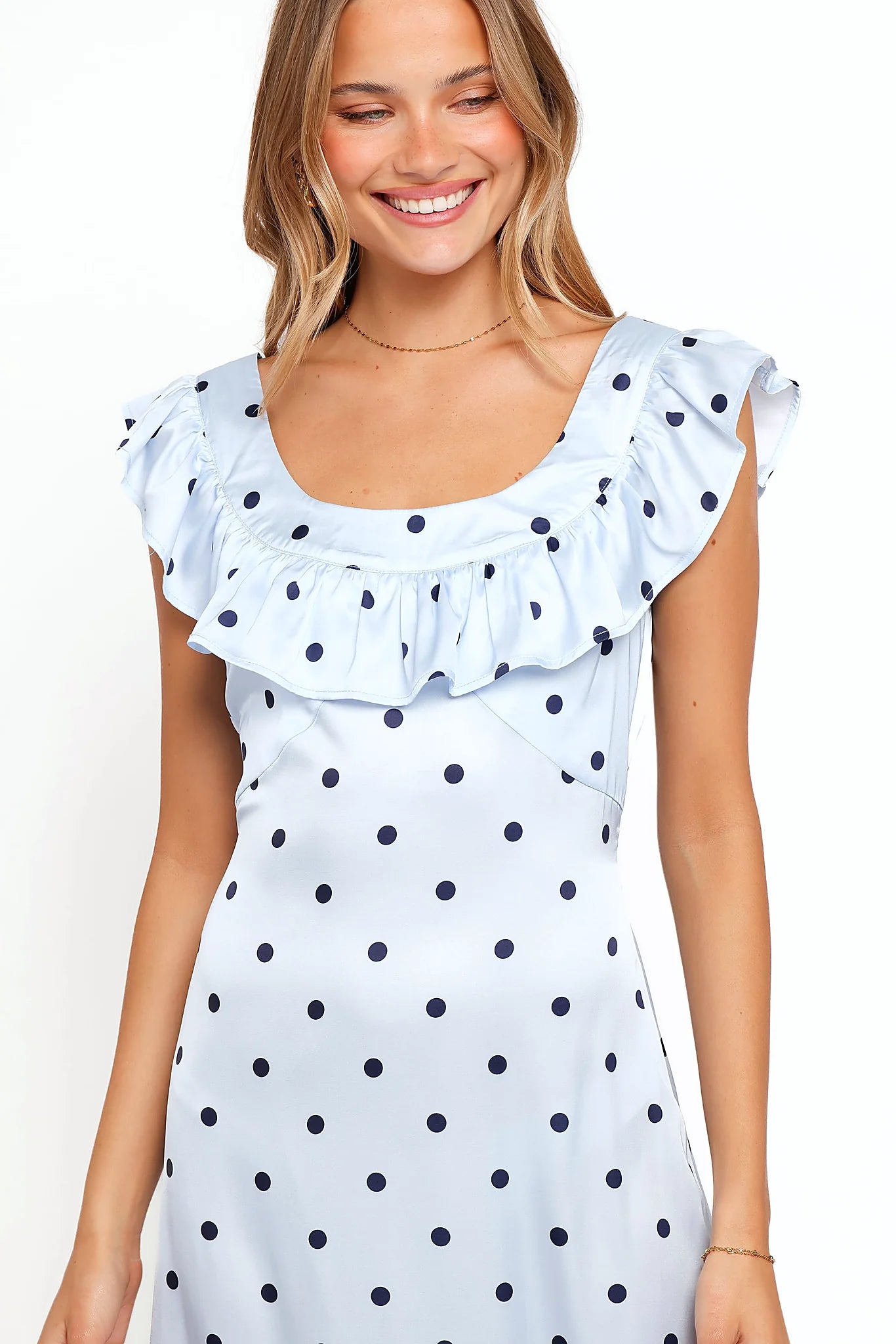 Model wearing the blue polka dot off-shoulder maxi dress, front view