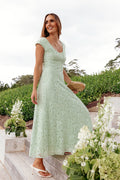 Model wearing the sage green lace maxi dress, front view