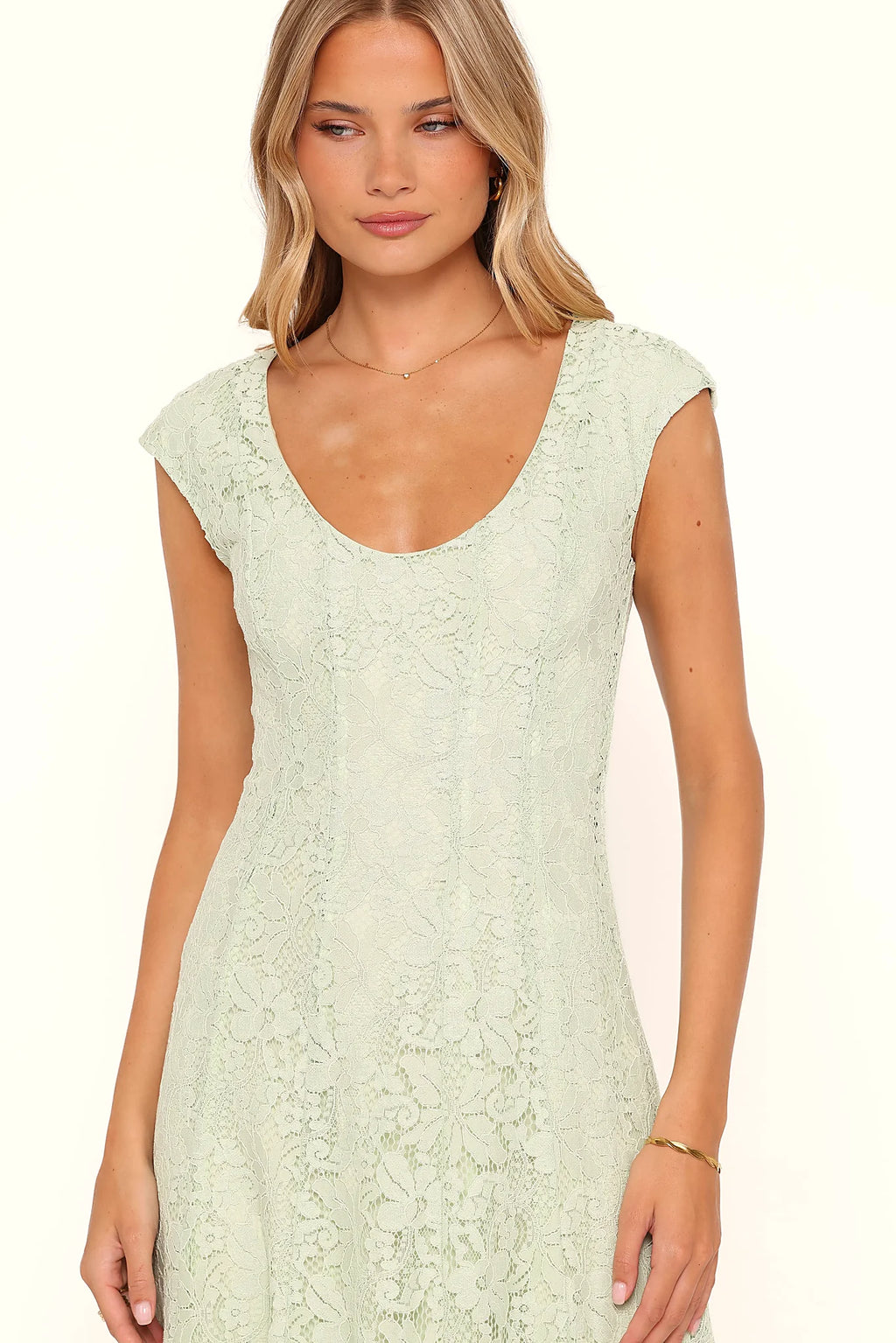 Side view showing the drape of the sage green lace maxi dress