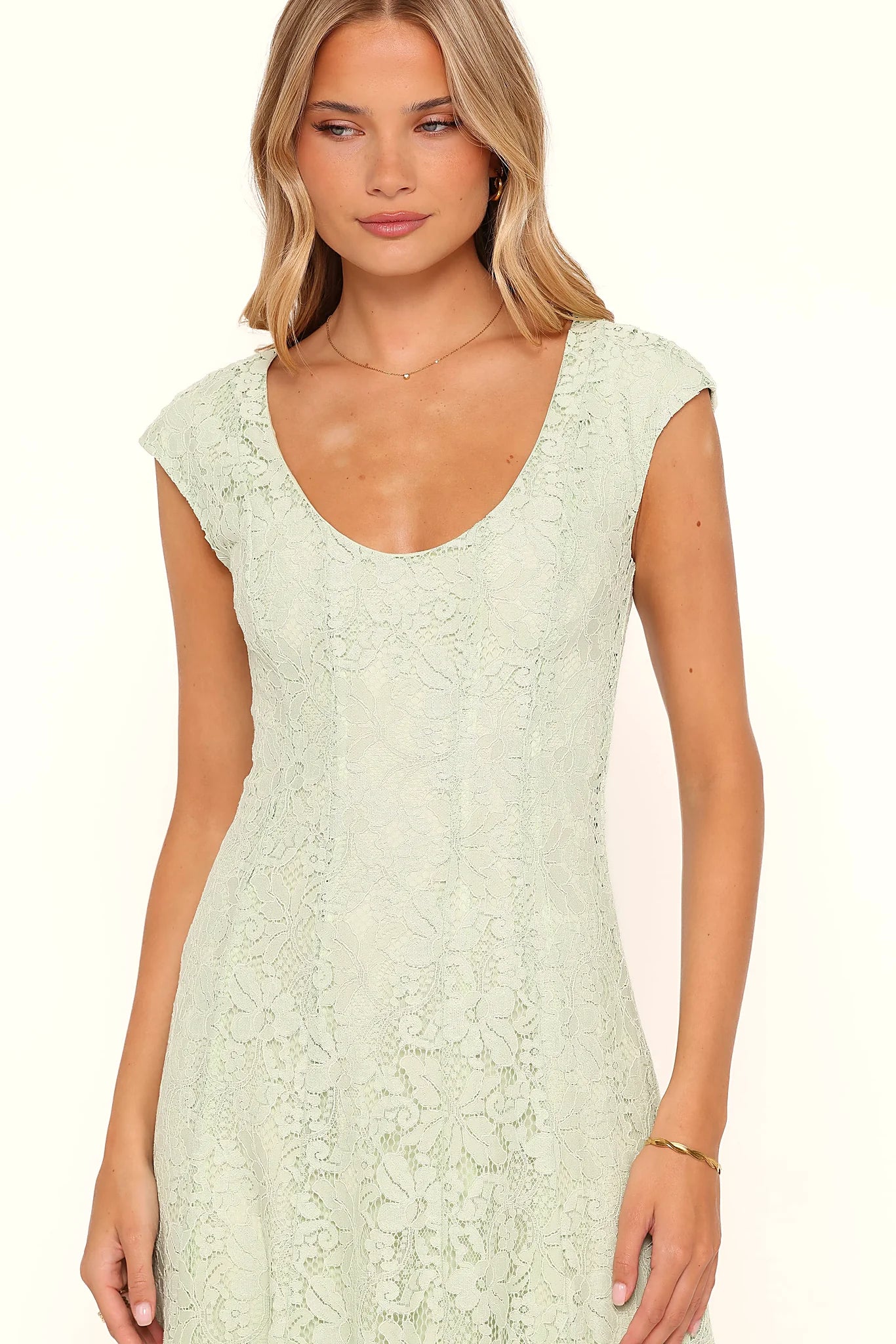 Side view showing the drape of the sage green lace maxi dress
