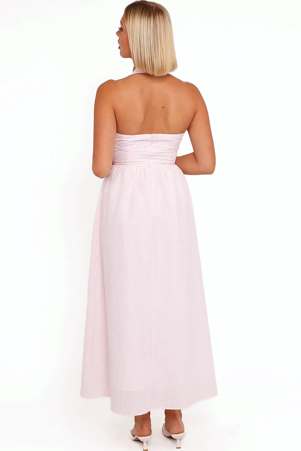 Side view showing the drape of the pink gingham halter midi dress