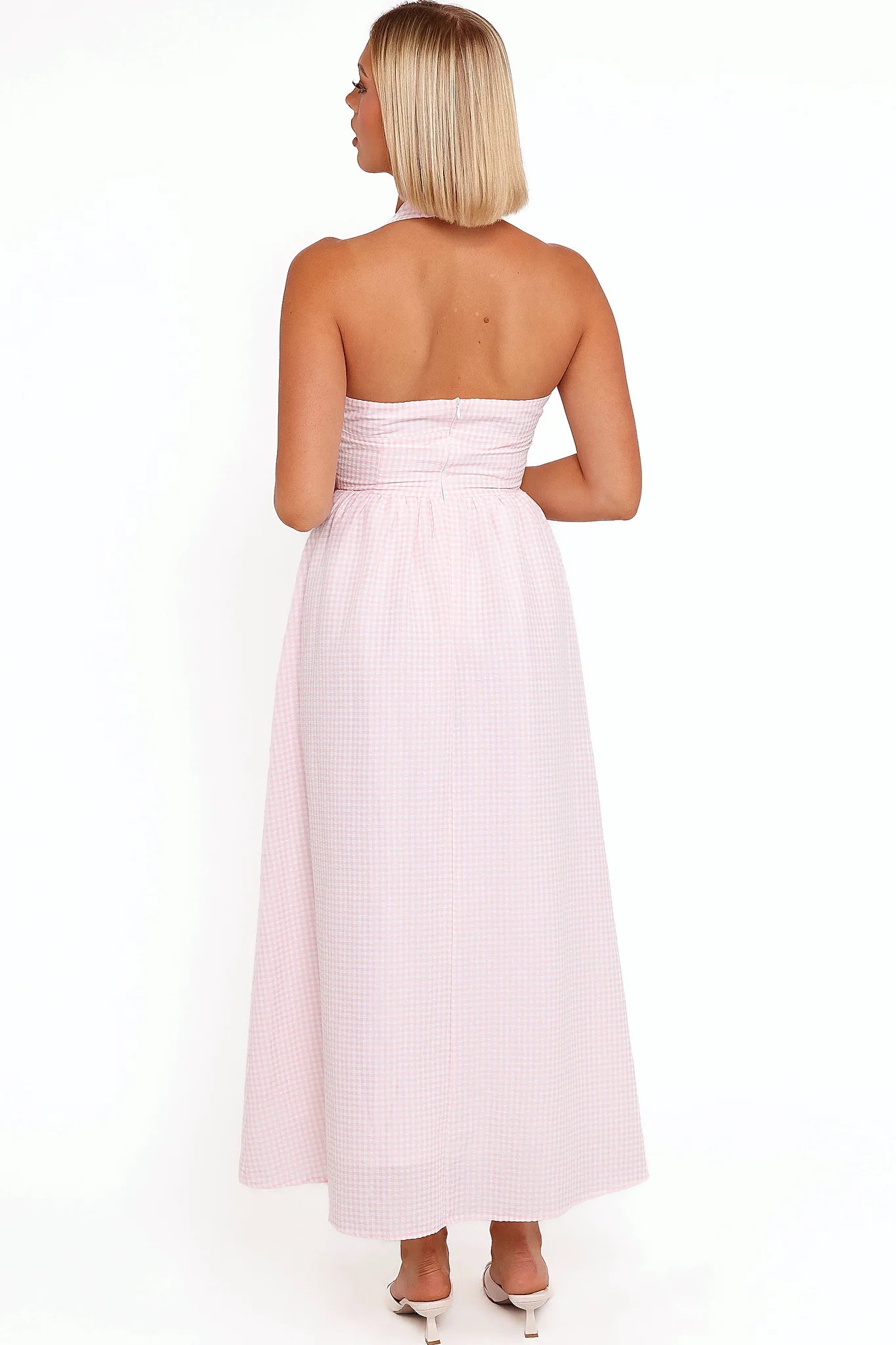 Side view showing the drape of the pink gingham halter midi dress