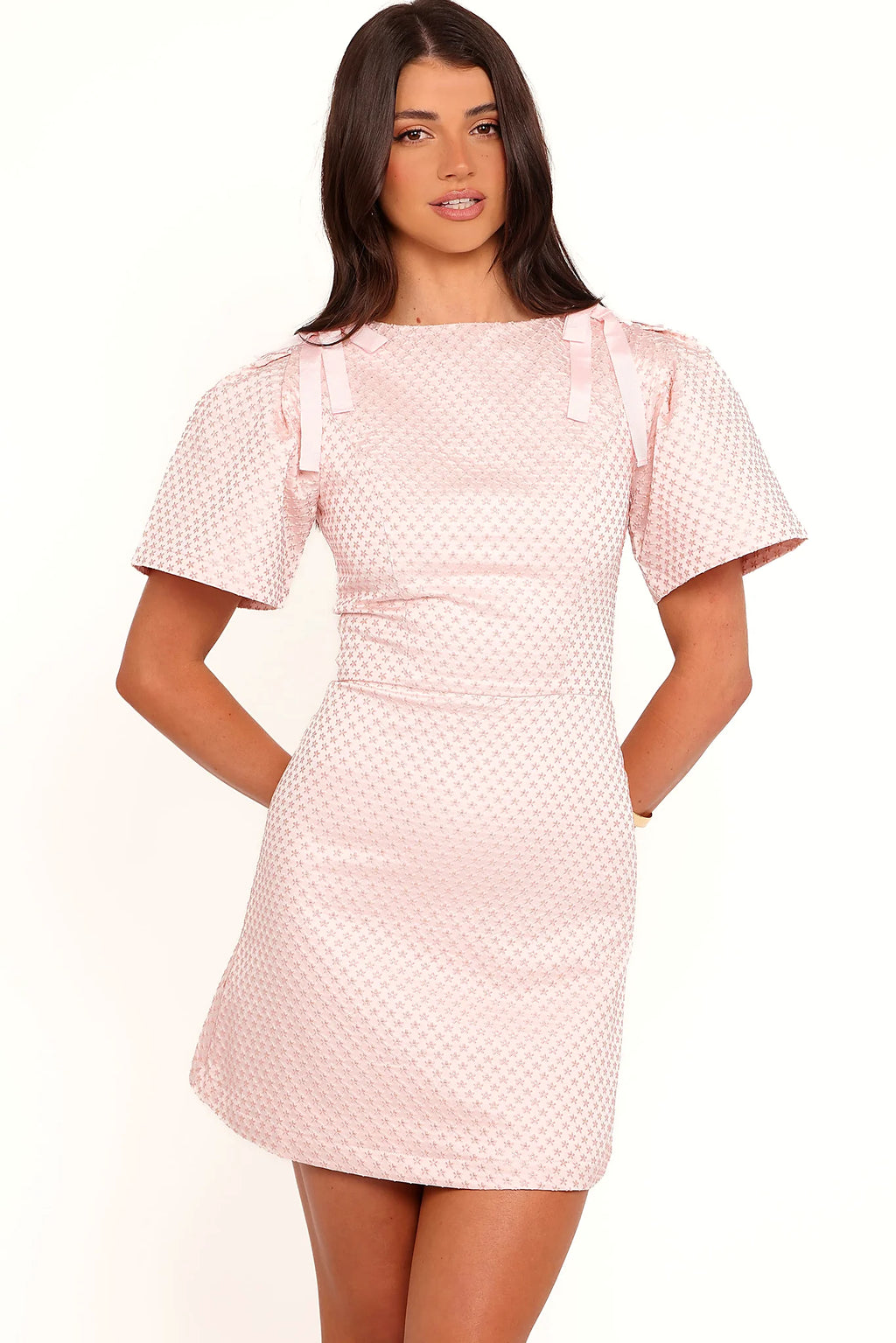 Side view showing the drape of the pink rose brocade mini dress