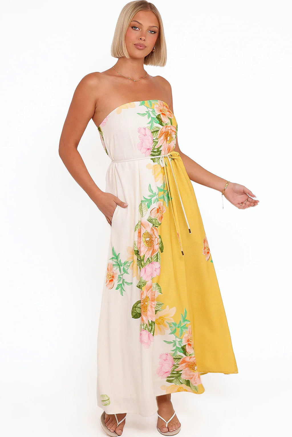 Side view showing the drape of the yellow poppy strapless maxi dress