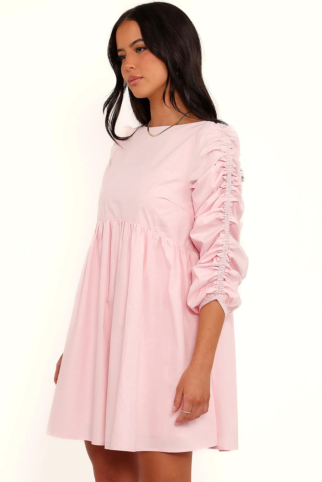 Close-up of the neckline of the pink smock long sleeve mini dress