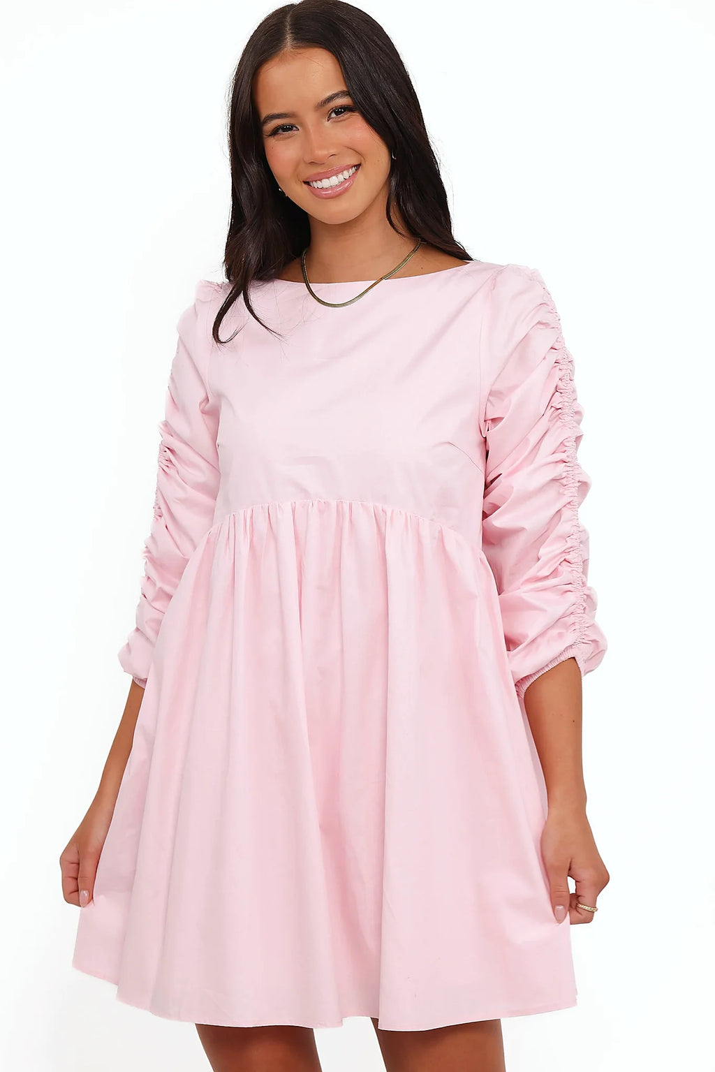 Full-length view of the pink smock long sleeve mini dress