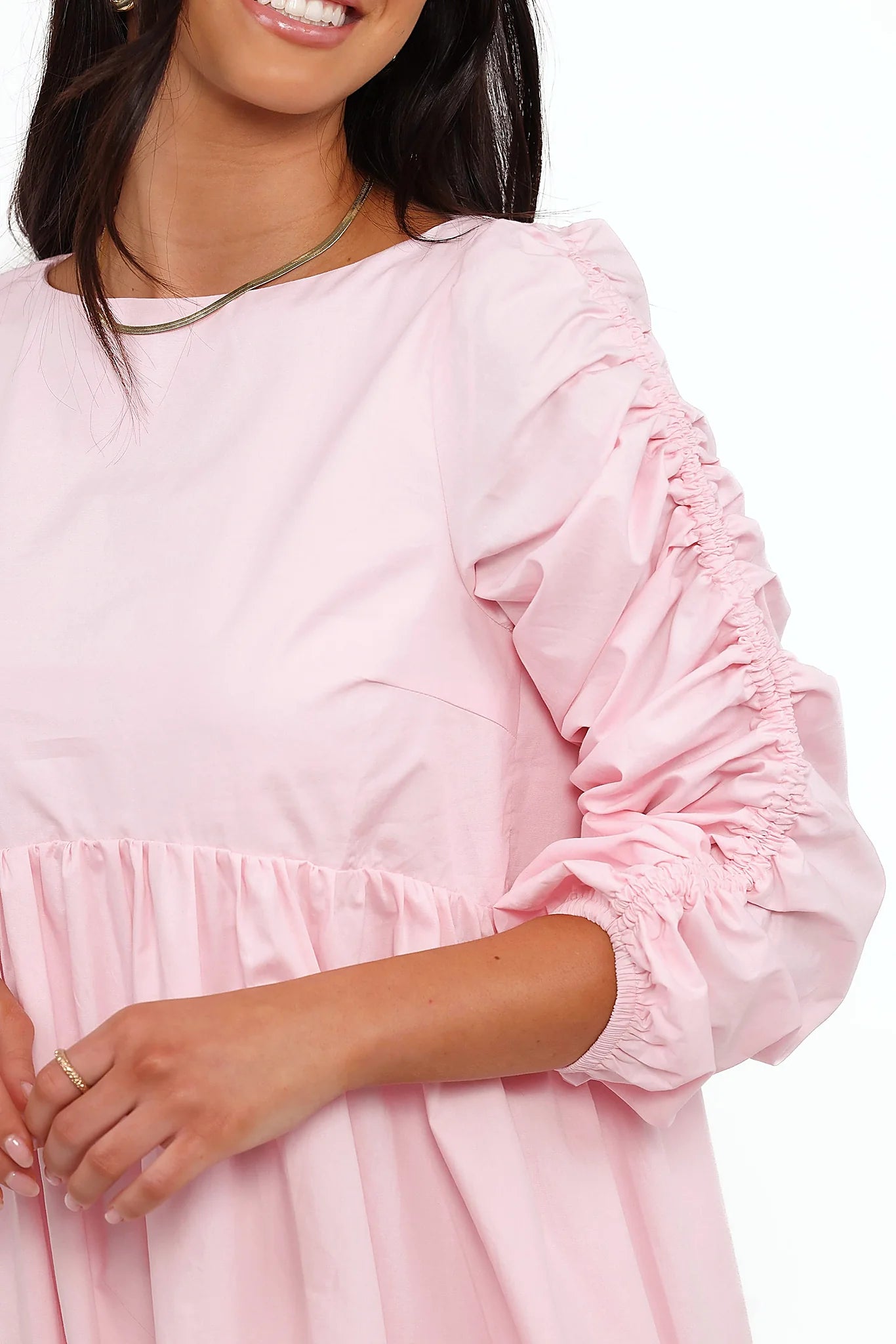 Detail view of the pink smock long sleeve mini dress