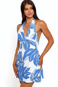 Model wearing the blue palm halterneck mini dress, front view