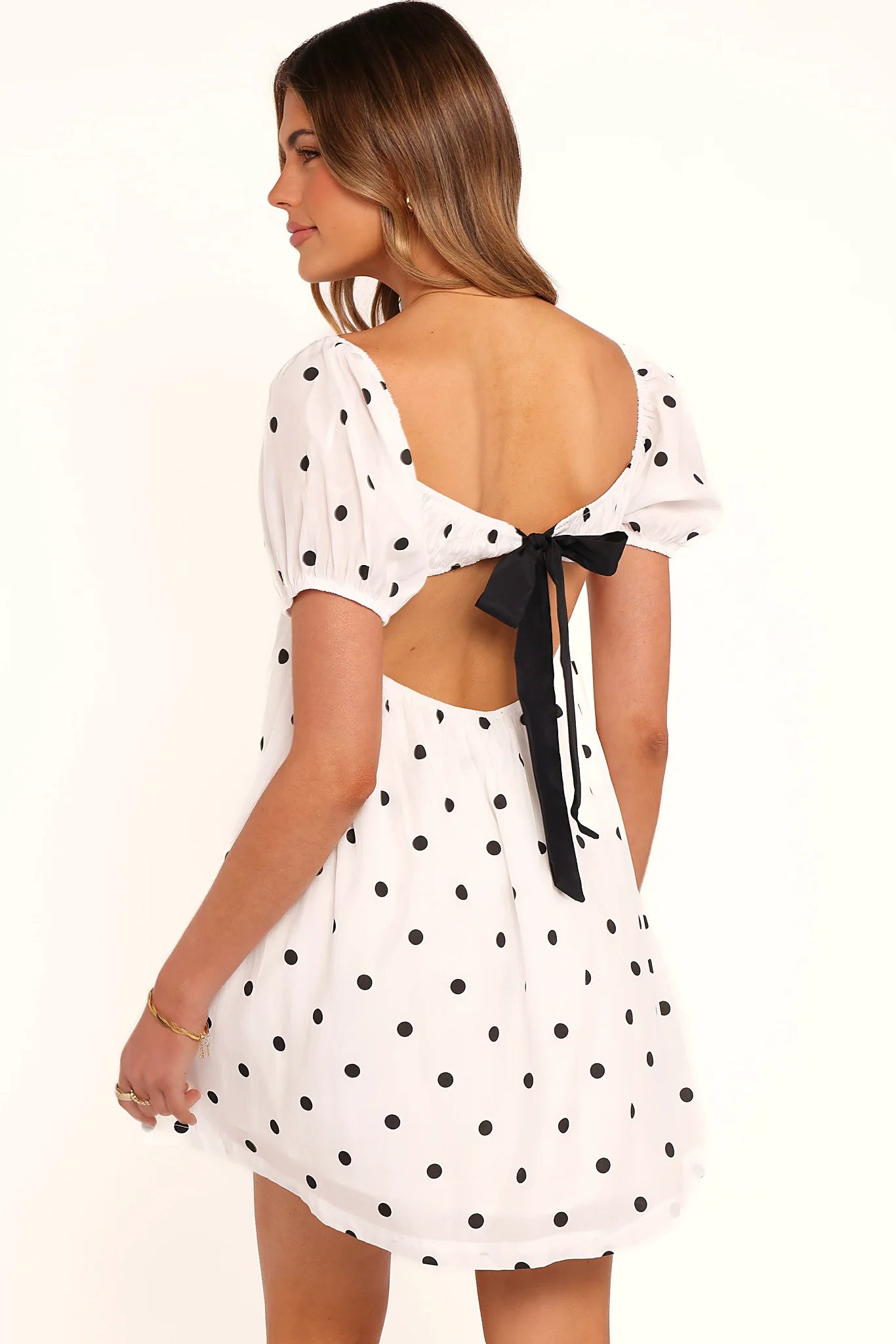 Detail view of the black polka dot babydoll mini dress