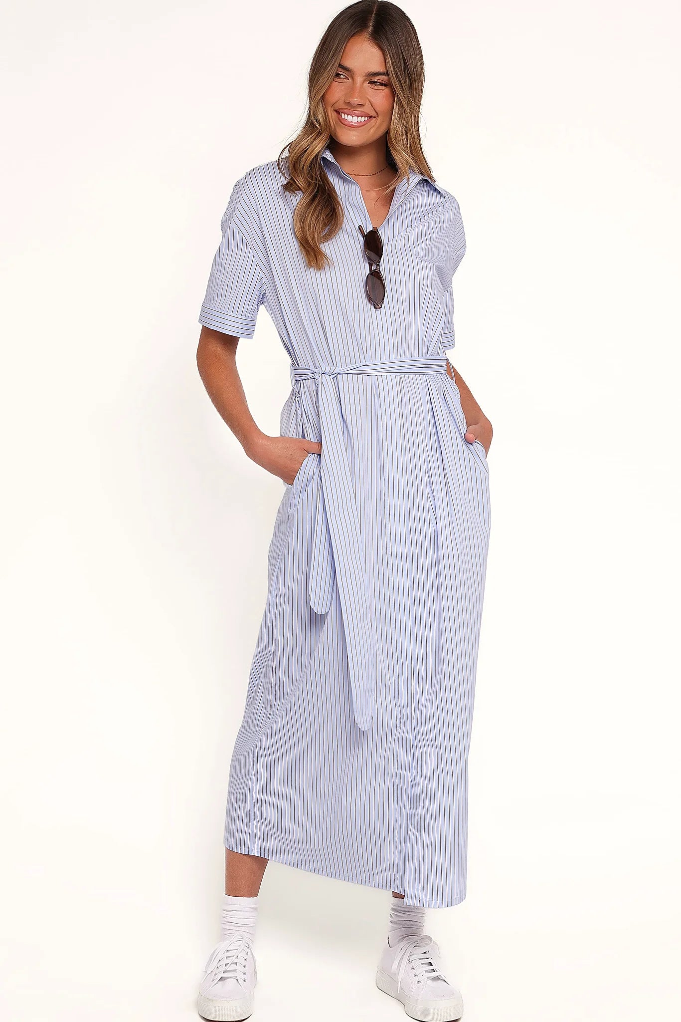Back view of the blue & brown stripe shirt dress on a model