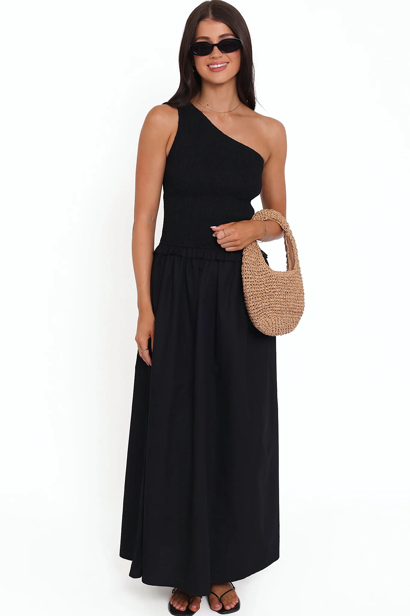 Model wearing the black one-shoulder maxi dress, front view
