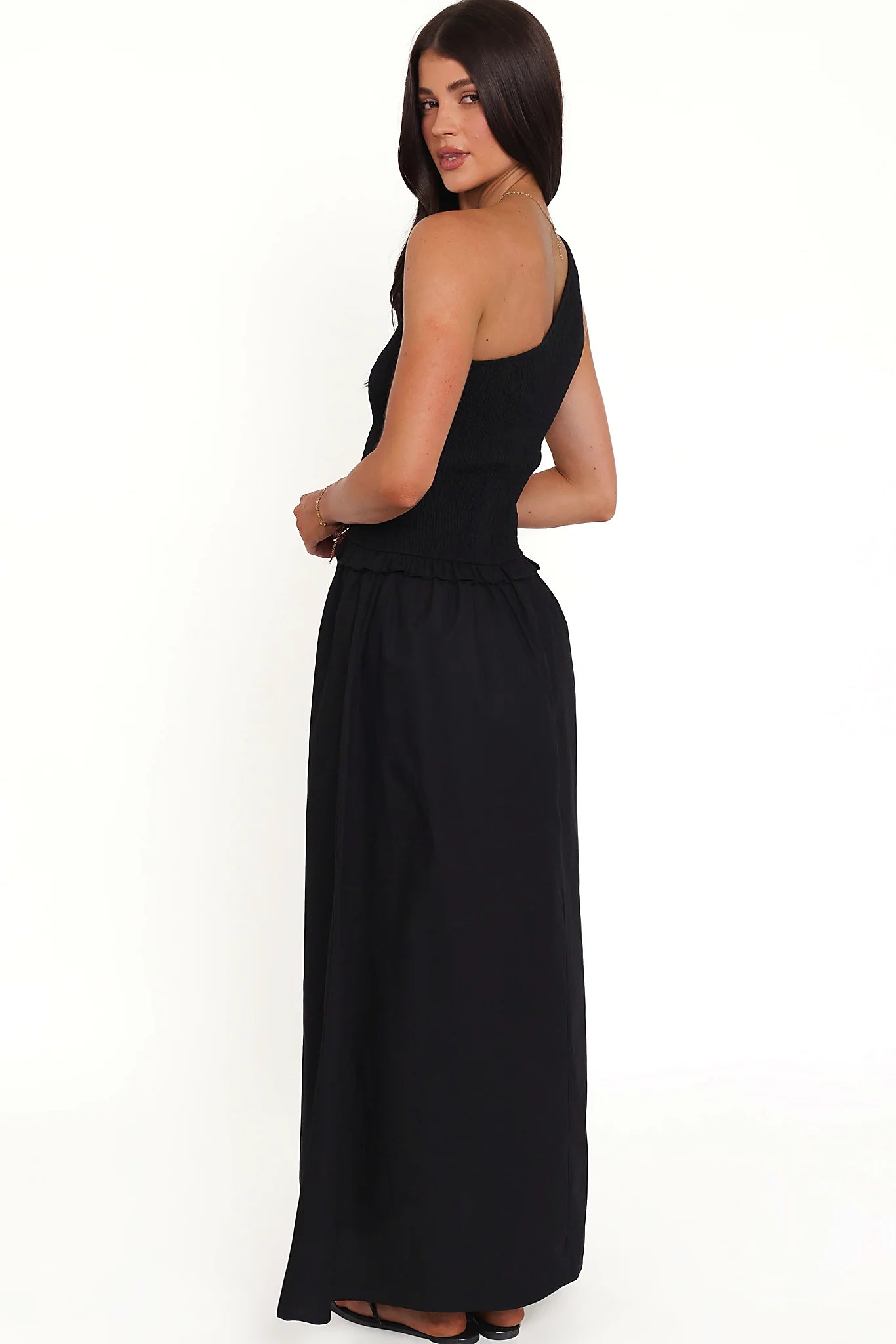 Full-length view of the black one-shoulder maxi dress