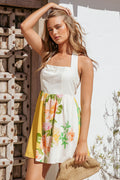 Close-up of the neckline of the yellow poppy halter mini dress